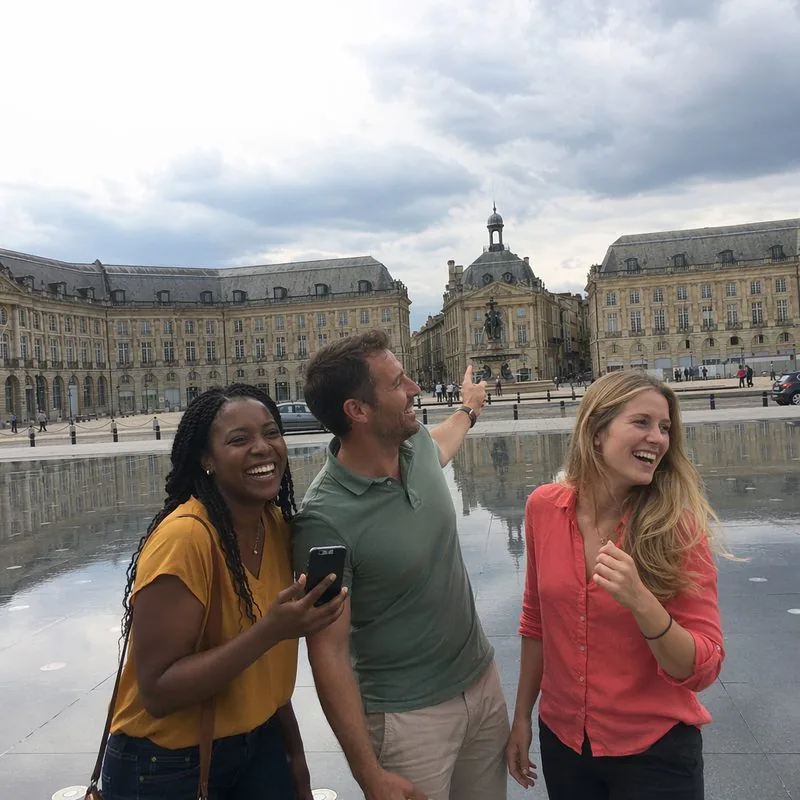 Trois collègues souriants sur le Miroir d'eau