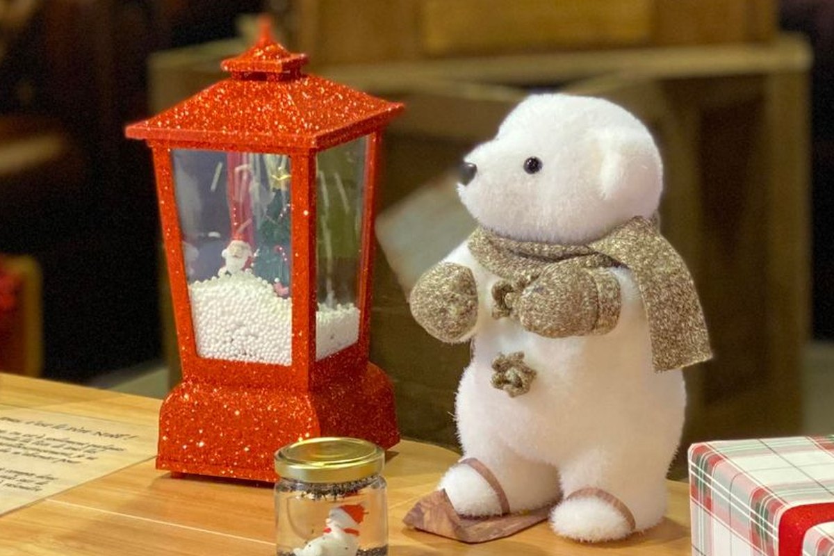 Escape game de Noël mobile, gros plan sur la lanterne rouge à neige et l'ours polaire à écharpe dorée du bureau du Père Noël